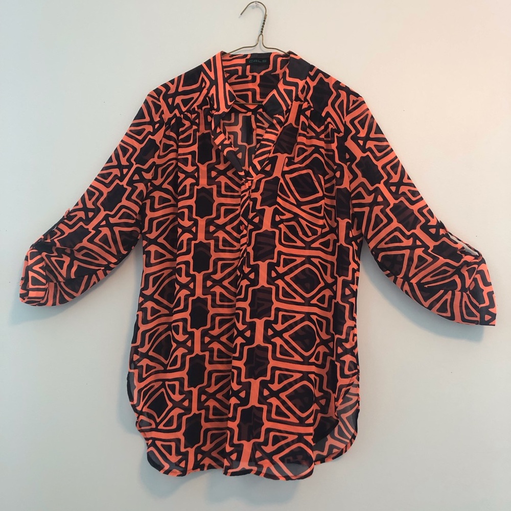 Sheer blouse with adjustable sleeves.